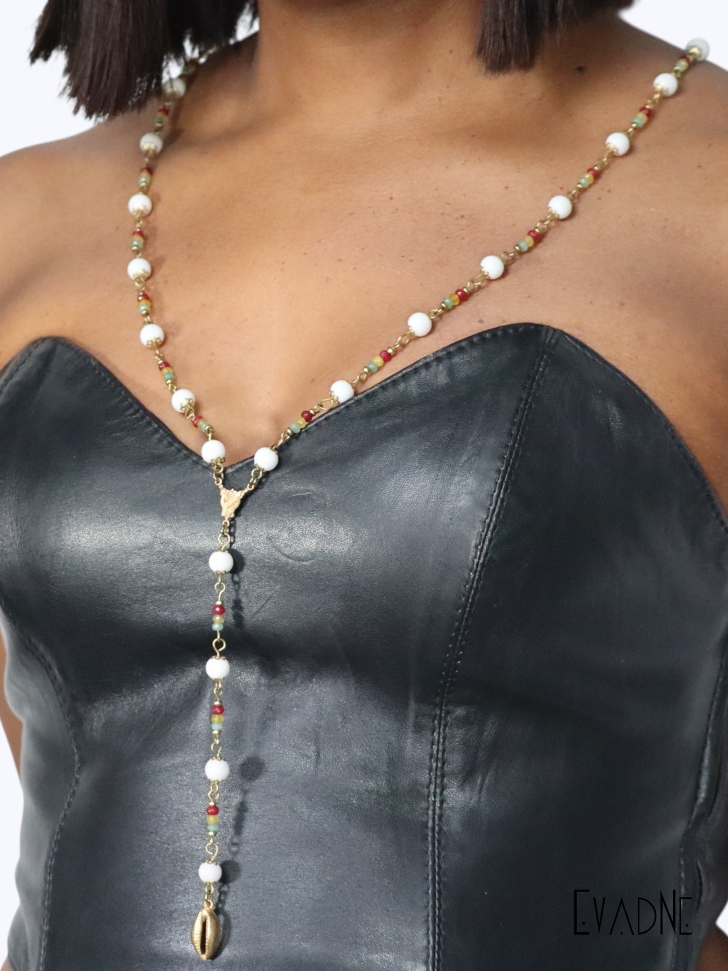 Rasta Rosary crafted with 8mm brass capped smooth white agate beads accentuated Rasta inspired jade gems and finished with brass links and cowrie shell charm.