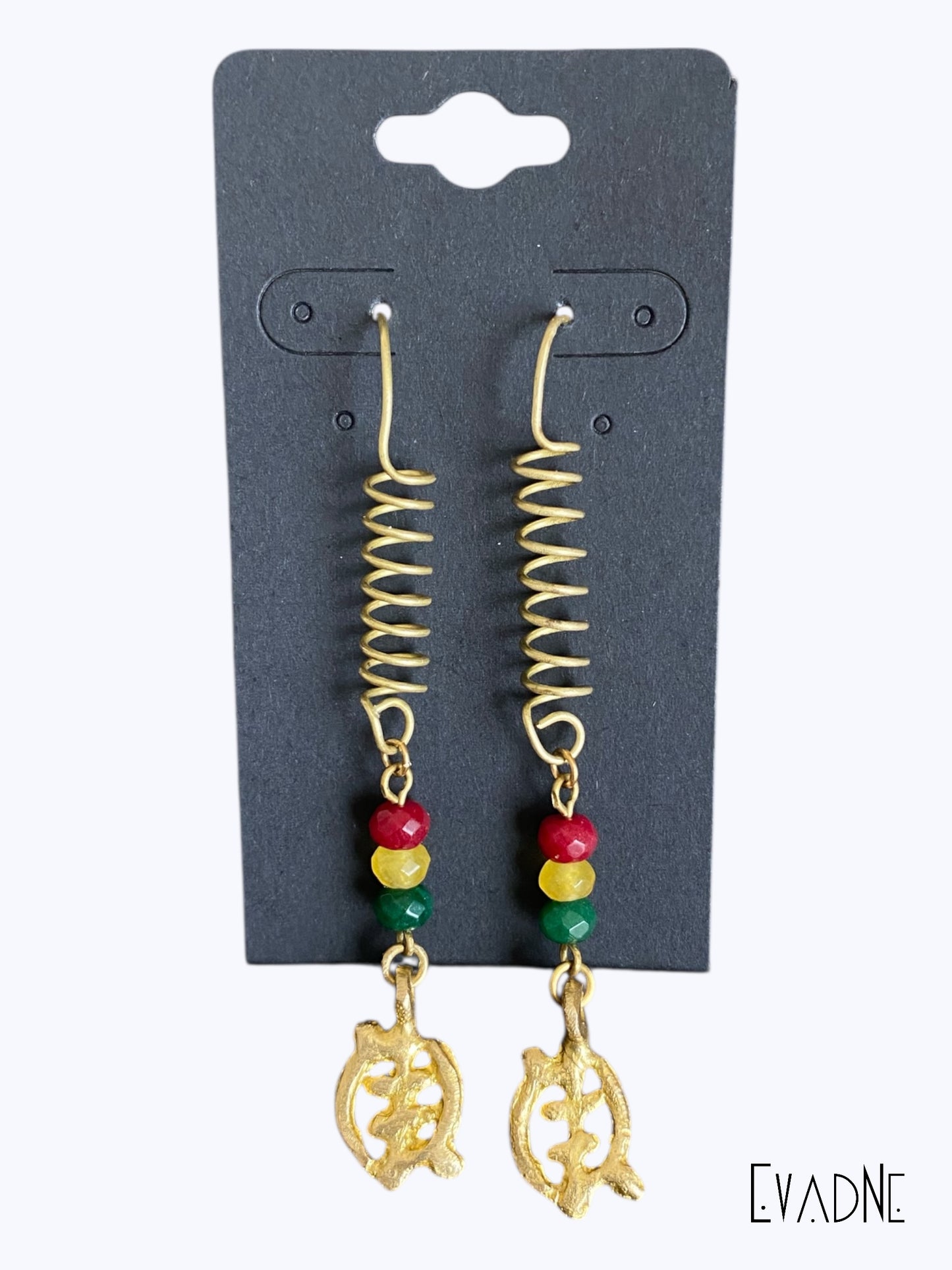 Gold spiral earrings with Rasta inspired jade beads on a black card, branded 'EVADNE'.