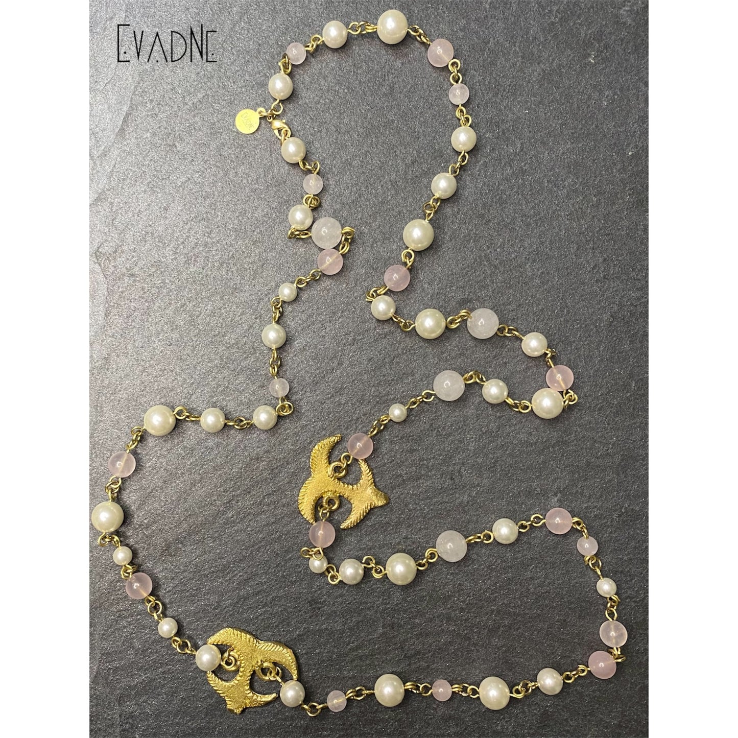 Faux pearl and rose quartz bead necklace with brass links, showcasing alternating pink and ivory beads.