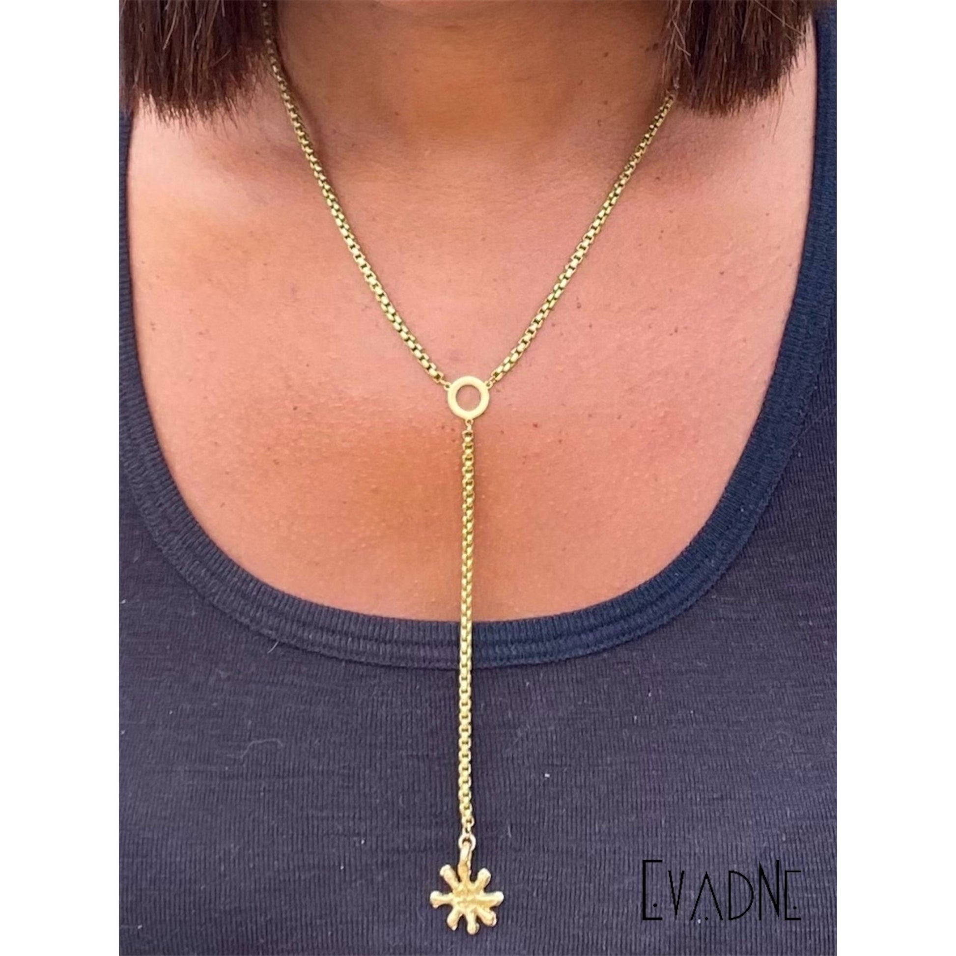 minimal brass Adinkra necklace worn for intentional everyday styling